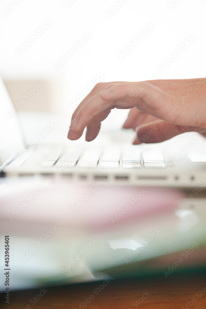 Close up of hand using laptop at desk Close up of hand using laptop at desk