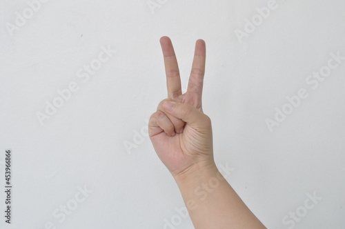 Women back peace sign two fingers © DAYDREAMRDIGITAL