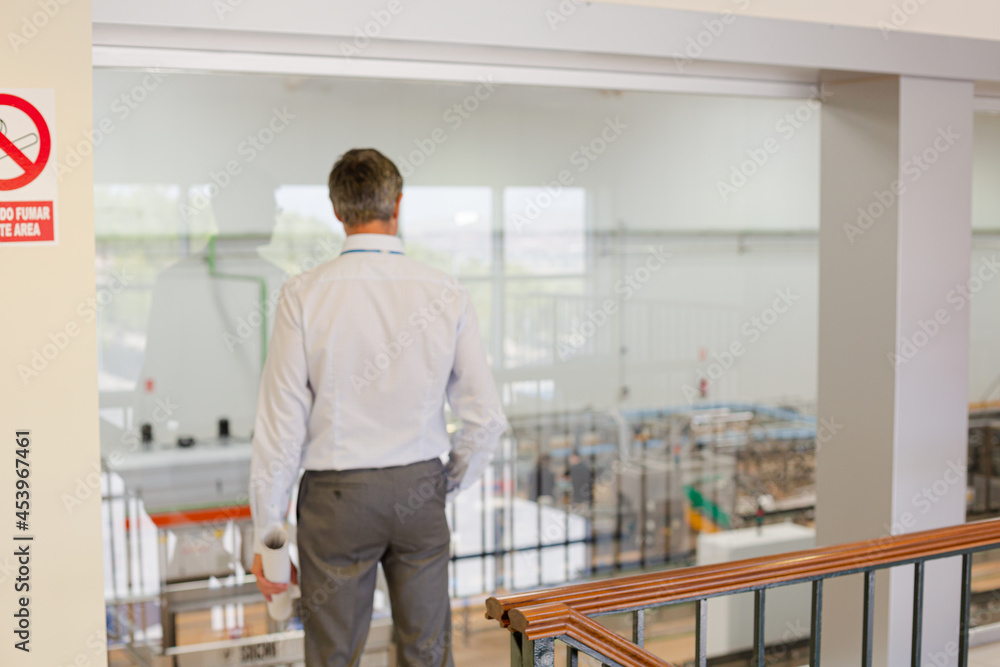 Businessman looking out glass window Businessman looking out glass window