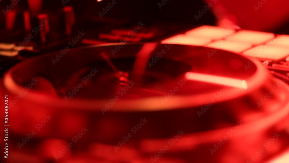 Close-Up of Dj Mixer Controller Desk in Night Club Disco Party. DJ Hands touching Buttons and Sliders Playing Electronic Music . Amazing Close Up of DJ Hands Mixing and Scratching Music on Vinyl Plate Close-Up of Dj Mixer Controller Desk in Night Club Disco Party. DJ Hands touching Buttons and Sliders Playing Electronic Music . Amazing Close Up of DJ Hands Mixing and Scratching Music on Vinyl Plate
