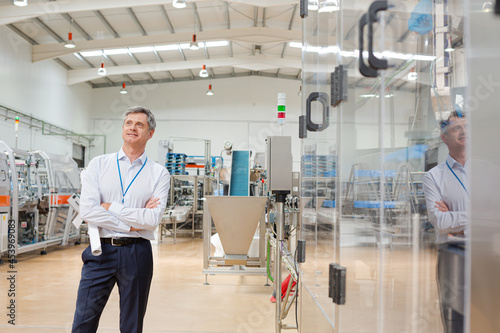 Businessman standing in factory