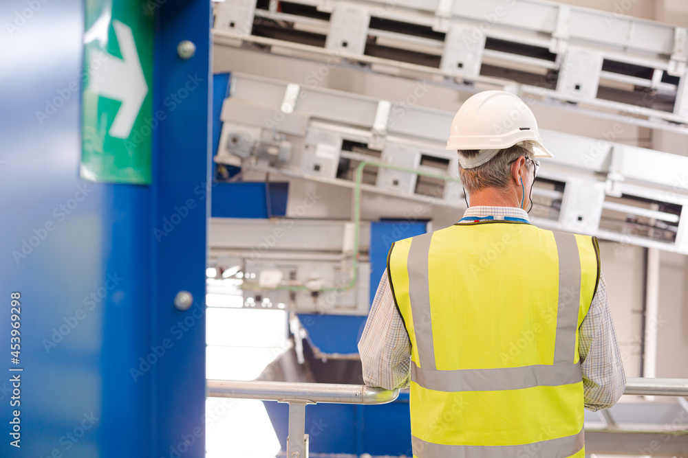 Worker on platform in recycling center Worker on platform in recycling center