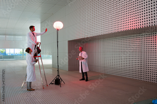 Scientists testing llamp in modern building photo