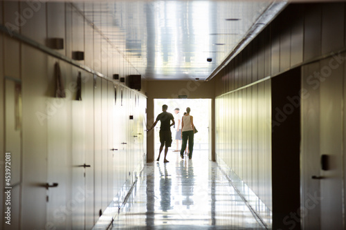 People walking in corridor inside modern building