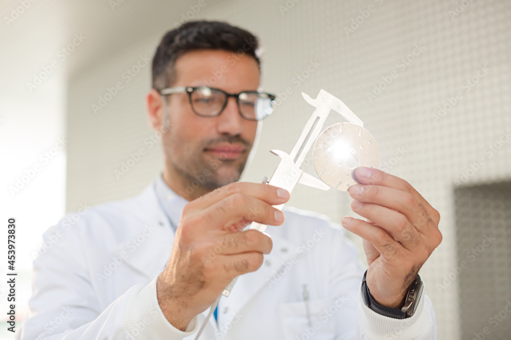 Scientist using caliper Scientist using caliper