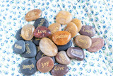 Motivational zen inspirational stones with writings. Serenity, gratitude, passion, love on a background
