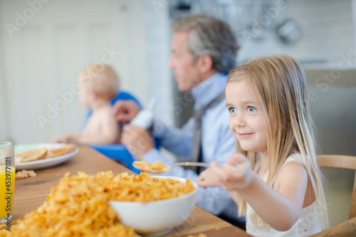 Girl eating overflowing bowl of cereal
