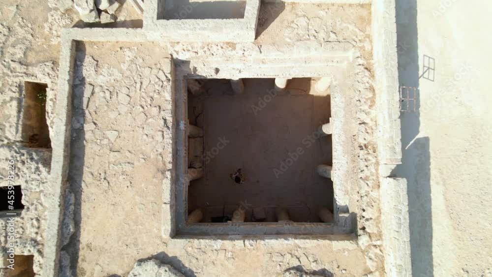 Aerial view above a man walking inside the ruins of Kato Paphos Archelogical park, in Cyprus - top down, drone shot Aerial view above a man walking inside the ruins of Kato Paphos Archelogical park, in Cyprus - top down, drone shot