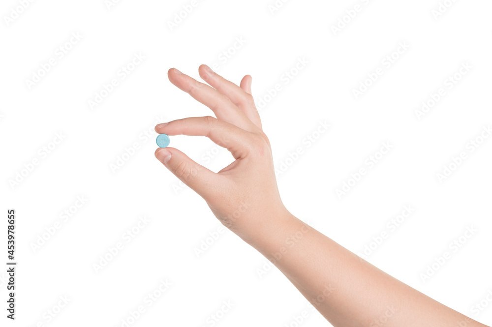 Woman hand holding a medicine pill isolated on white background. Woman hand holding a medicine pill isolated on white background.