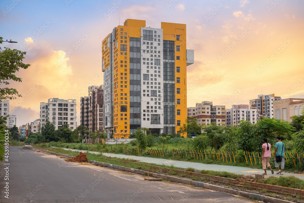 Modern residential apartment buildings with city road at New Town, Rajarhat, Kolkata at sunset Modern residential apartment buildings with city road at New Town, Rajarhat, Kolkata at sunset