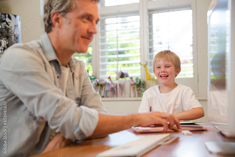 Father and son working in home office Father and son working in home office