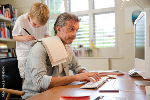 Photos Boy hugging working father