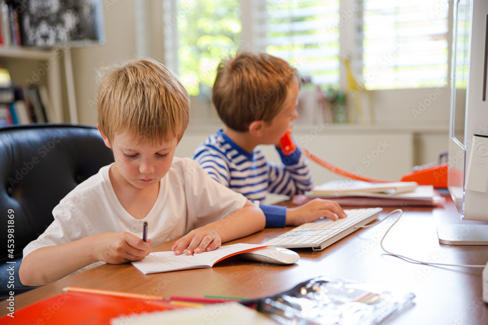 Boys using telephone in home office Boys using telephone in home office