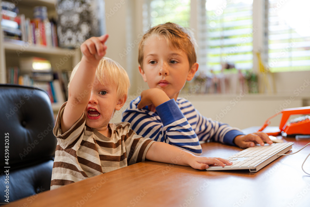 Boys working in home office Boys working in home office