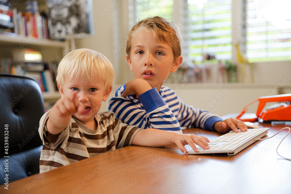 Boys working in home office Boys working in home office