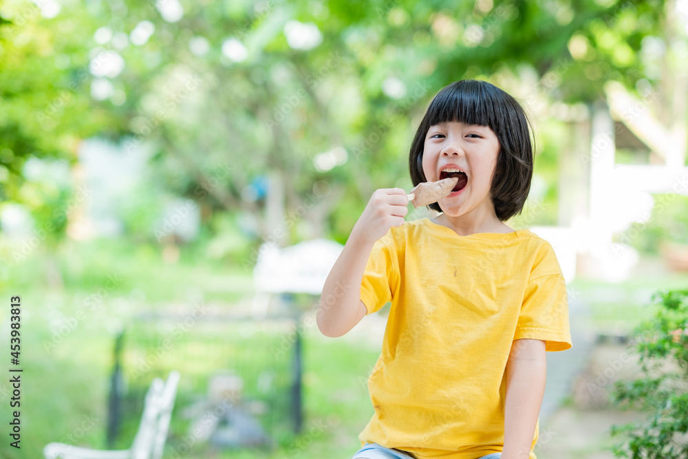 asian girl eating ice cream with blur background asian girl eating ice cream with blur background