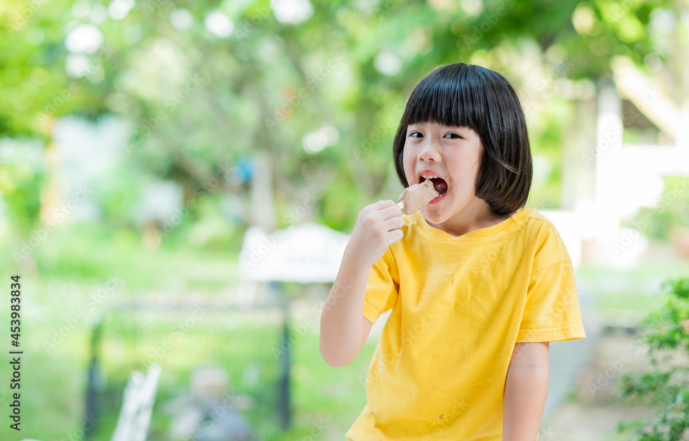 asian girl eating ice cream with blur background asian girl eating ice cream with blur background