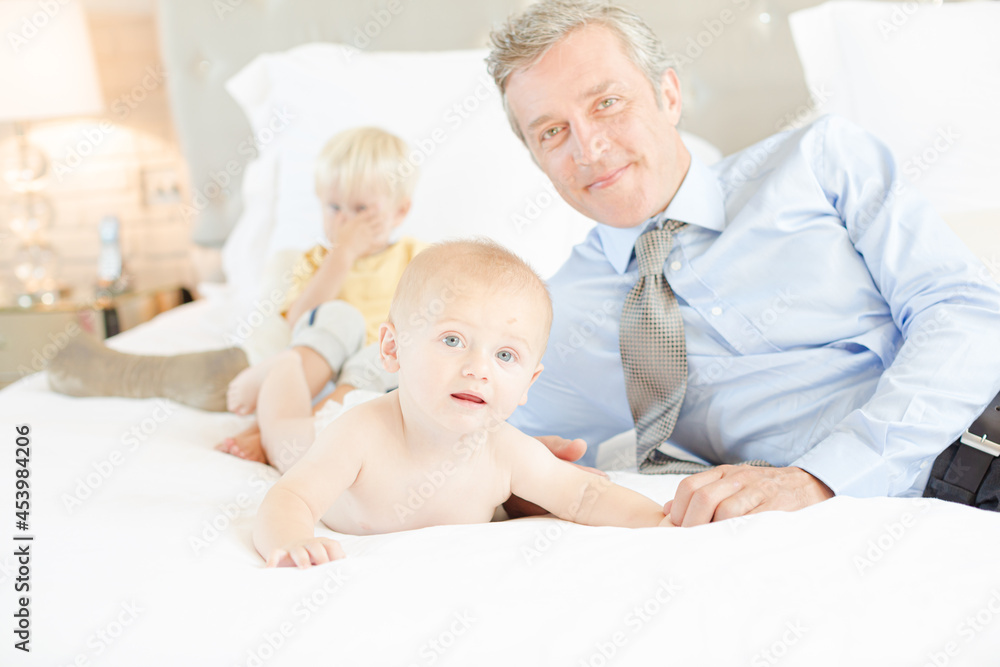 Father and children relaxing on bed Father and children relaxing on bed