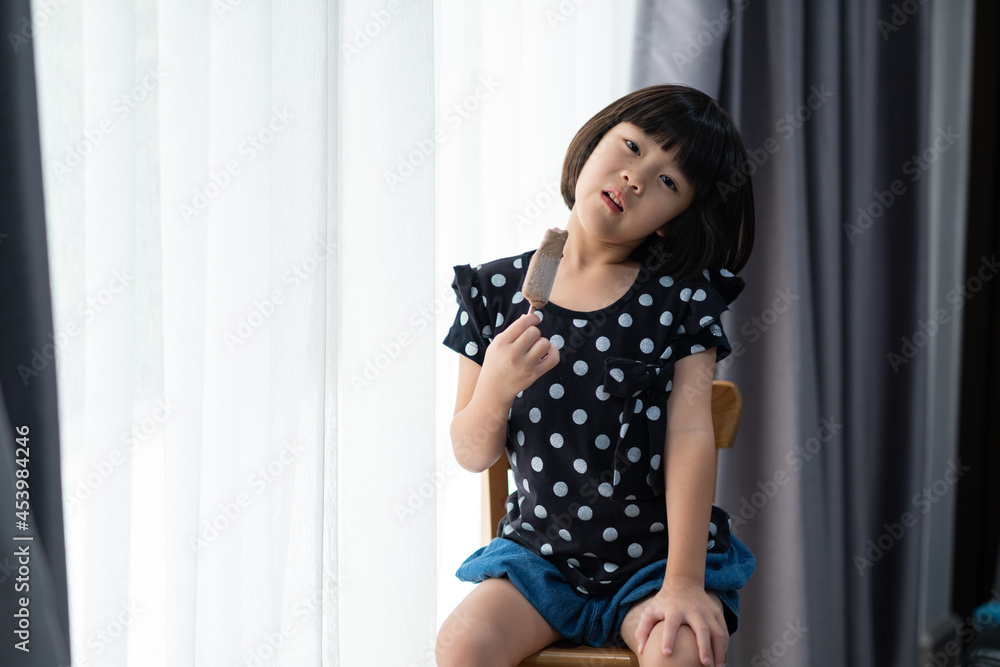 asian girl eating ice cream with blur background asian girl eating ice cream with blur background