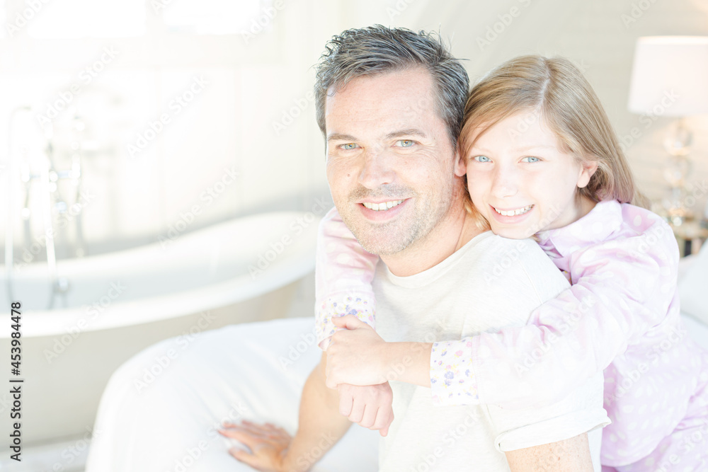 Father and daughter hugging in bedroom Father and daughter hugging in bedroom