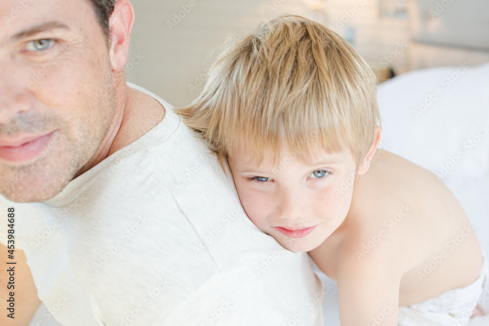 Boy hugging father in bathroom Boy hugging father in bathroom