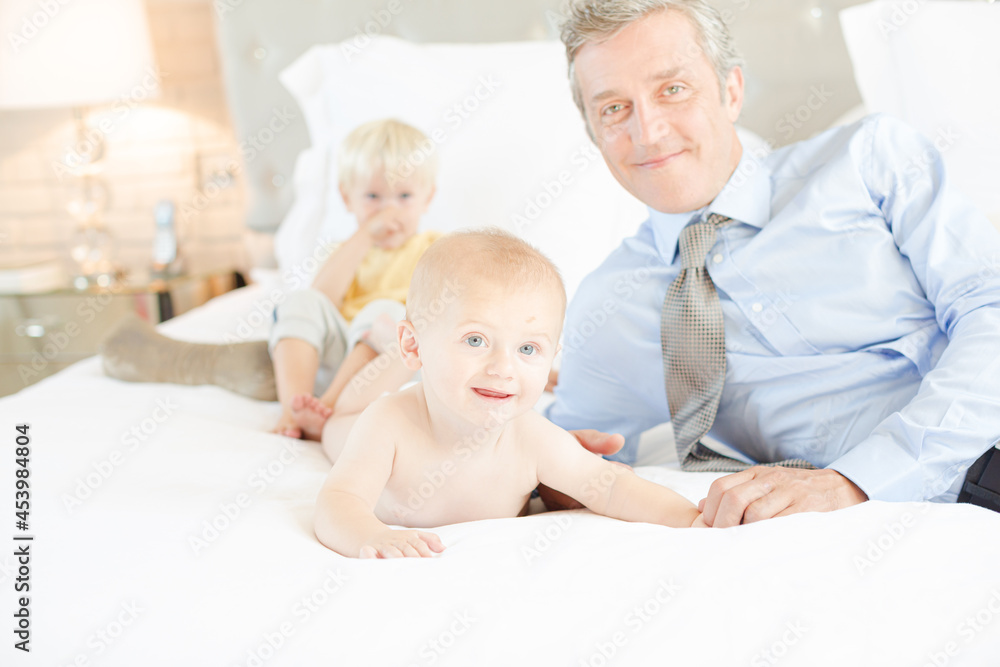 Father and children relaxing on bed Father and children relaxing on bed