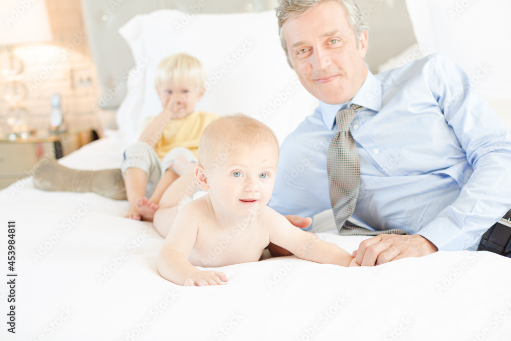 Father and children relaxing on bed Father and children relaxing on bed