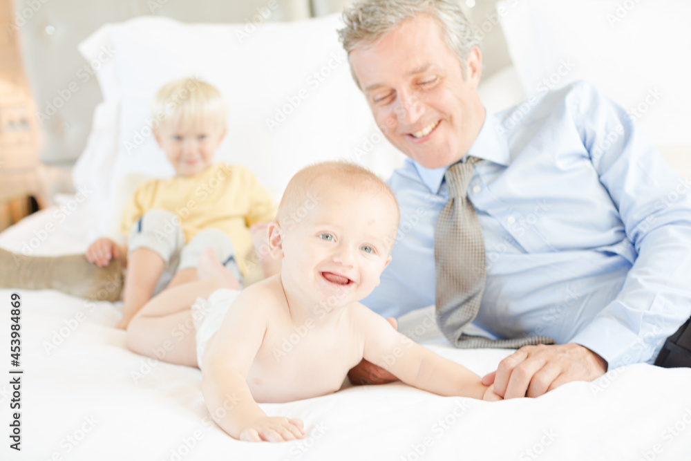 Father and children relaxing on bed Father and children relaxing on bed