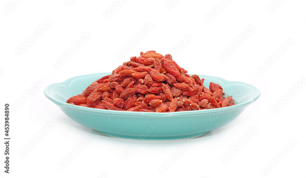 Goji berry in Chinese ceramic dish isolated on white background. Goji berry, or wolfberry. Used in traditional Chinese medicine and herbal tea ingredients , had anti-cancer properties. Goji berry in Chinese ceramic dish isolated on white background. Goji berry, or wolfberry. Used in traditional Chinese medicine and herbal tea ingredients , had anti-cancer properties.