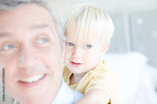 Father and son hugging on bed