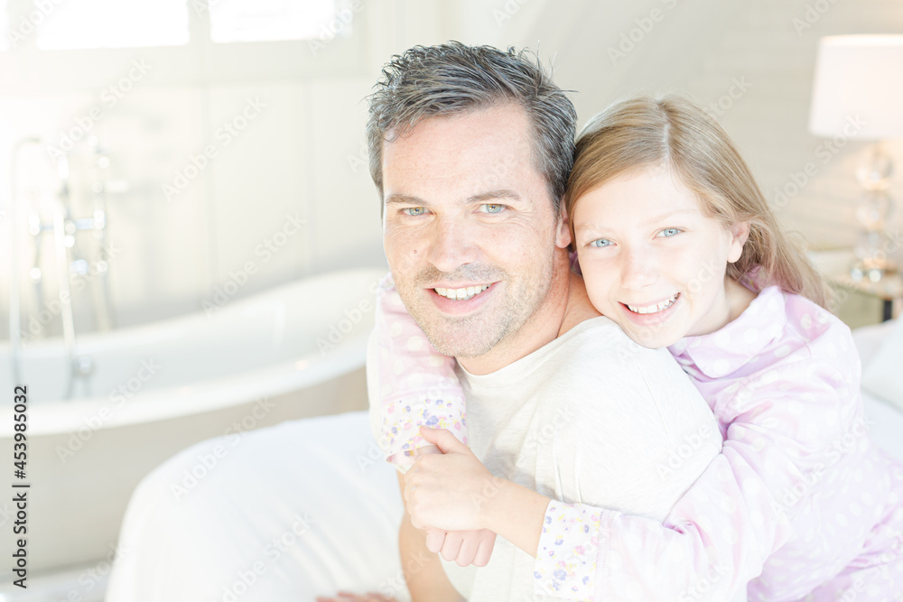 Father and daughter hugging in bedroom Father and daughter hugging in bedroom