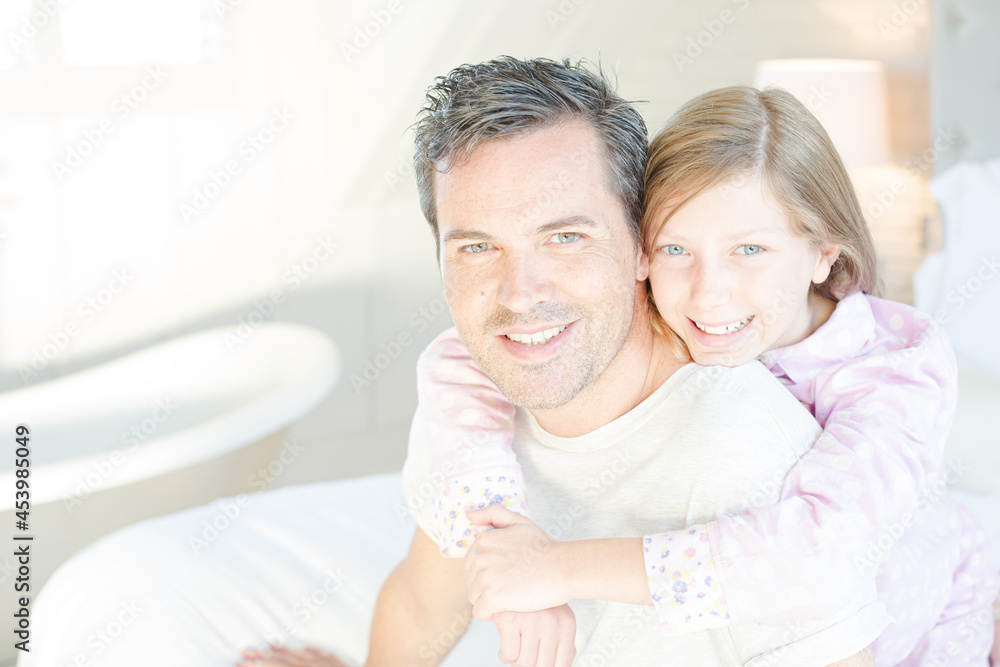 Father and daughter hugging on bed Father and daughter hugging on bed