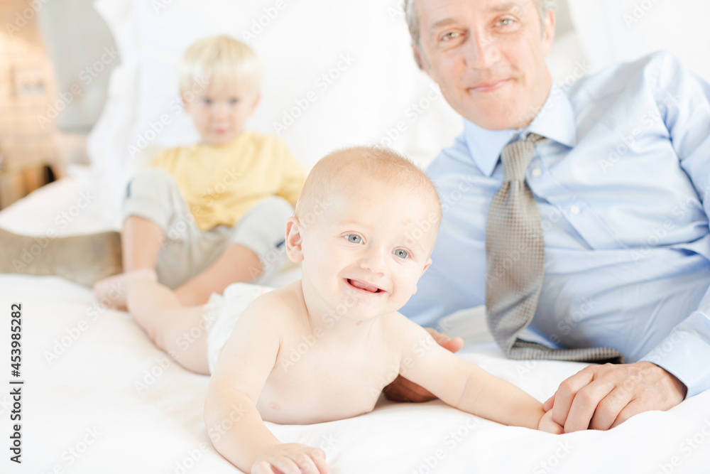 Father and children relaxing on bed Father and children relaxing on bed