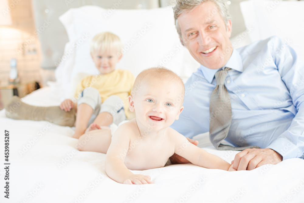 Father and children relaxing on bed Father and children relaxing on bed