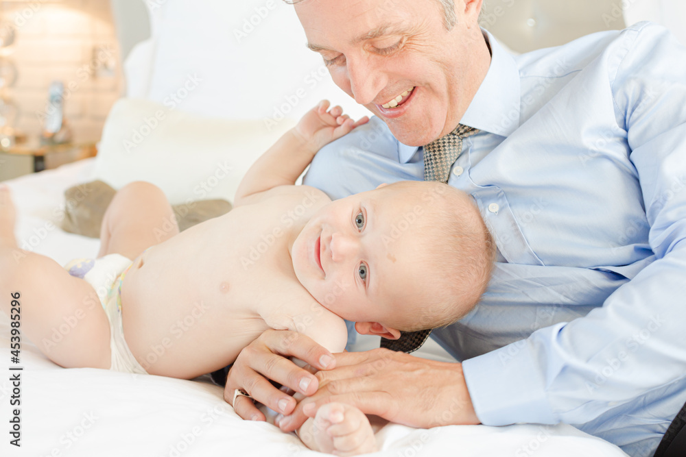 Father and baby laying on bed Father and baby laying on bed