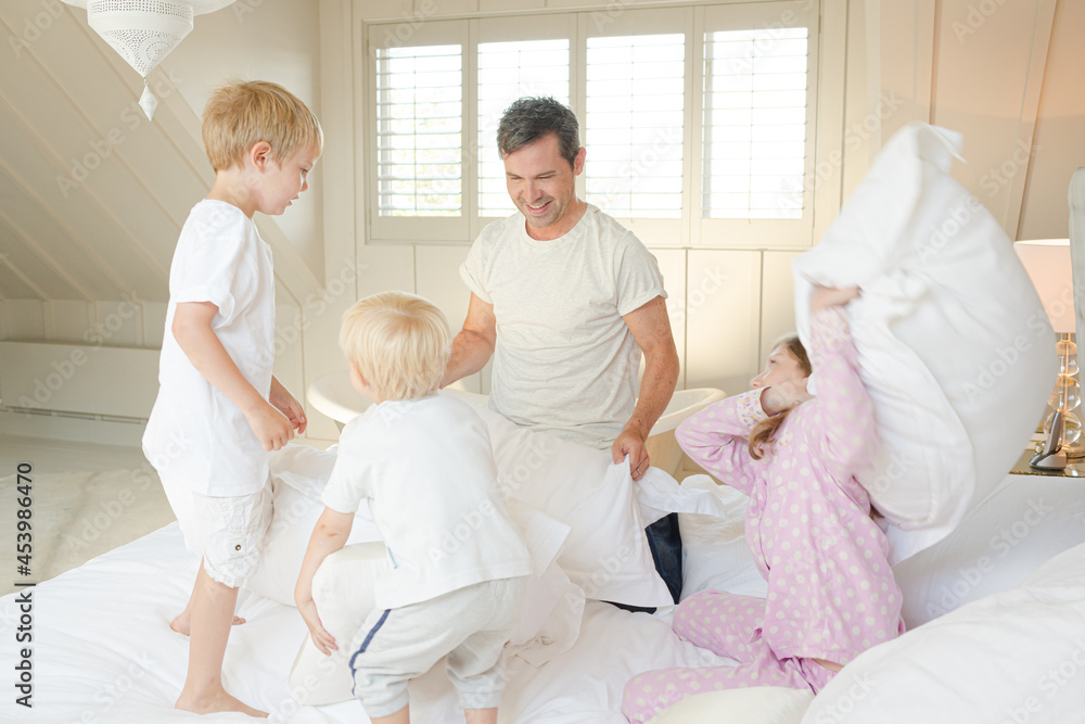 Father and children having pillow fight Father and children having pillow fight