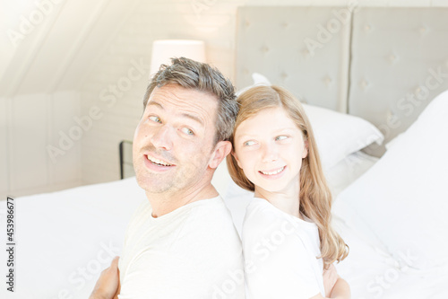 Father and daughter smiling in bedroom © KOTO