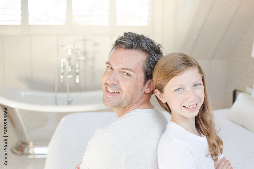 Father and daughter smiling in bedroom Father and daughter smiling in bedroom