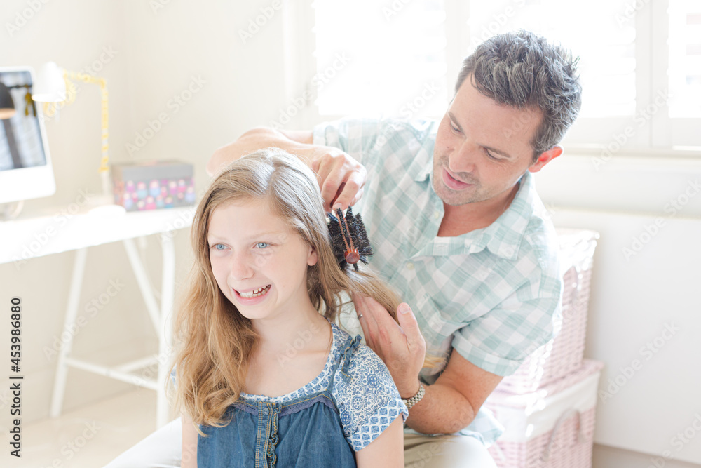 Father combing hair to his daughter - obrazy, fototapety, plakaty 