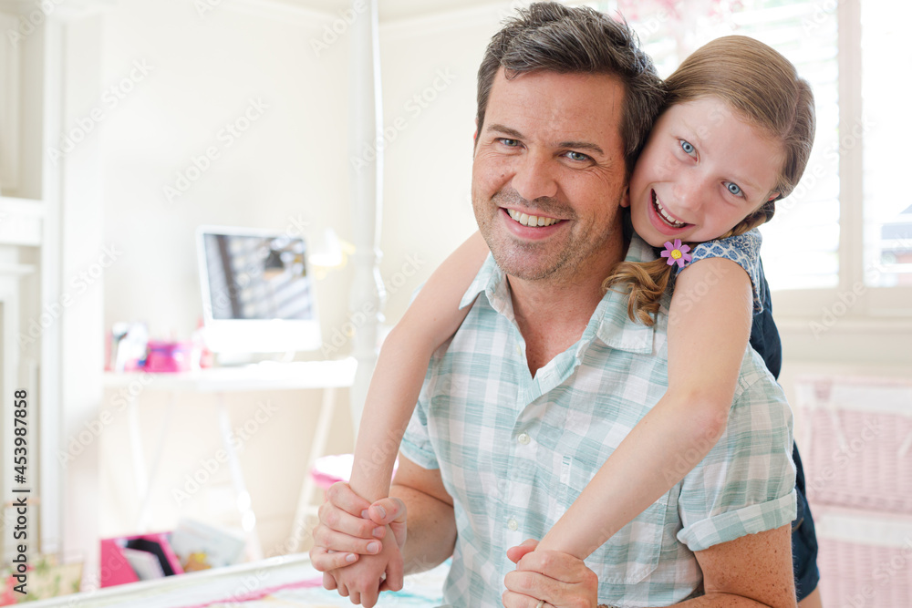 Fototapeta premium Father and daughter hugging in bedroom