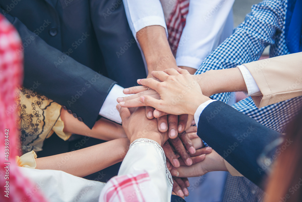 Fototapeta premium Diverse multiethnic Partners hands together teamwork group of multi racial people meeting join hands togetherness. Diversity people hands join empower partnership teams connection volunteer community