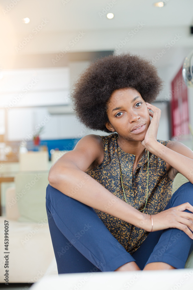 Smiling woman sitting in living room Smiling woman sitting in living room
