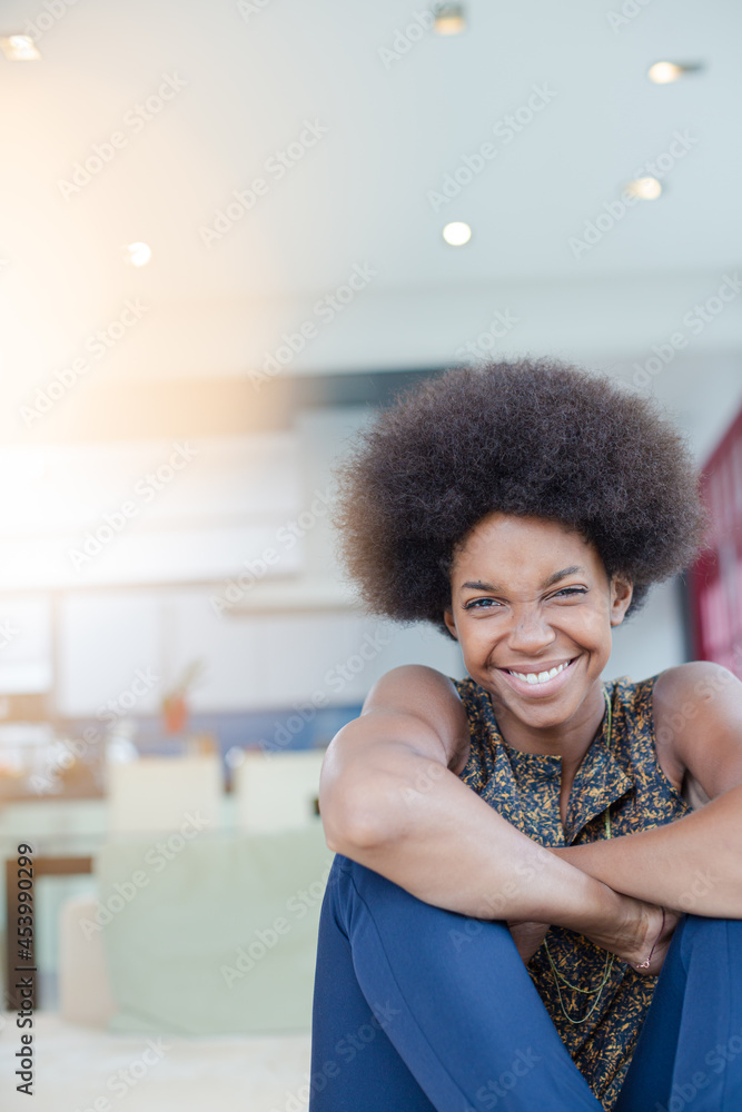 Smiling woman sitting in living room Smiling woman sitting in living room