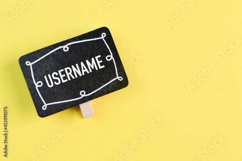 Wooden board with text USERNAME isolated on a yellow background