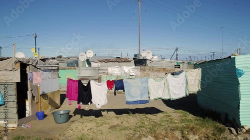 An informal settlement in Cape Town, South Africa. People live in poverty in shacks. There is a washing line in the foreground. photo