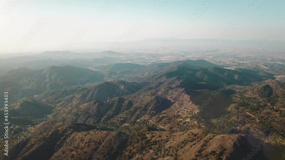 Aerial mountain range fog highland peaks. Sunlight in mount countryside area. Dry desert wilderness nature landscape. Eco tourism, travel. Nature background. Cinematic drone flight. Zoom out. Aerial mountain range fog highland peaks. Sunlight in mount countryside area. Dry desert wilderness nature landscape. Eco tourism, travel. Nature background. Cinematic drone flight. Zoom out.