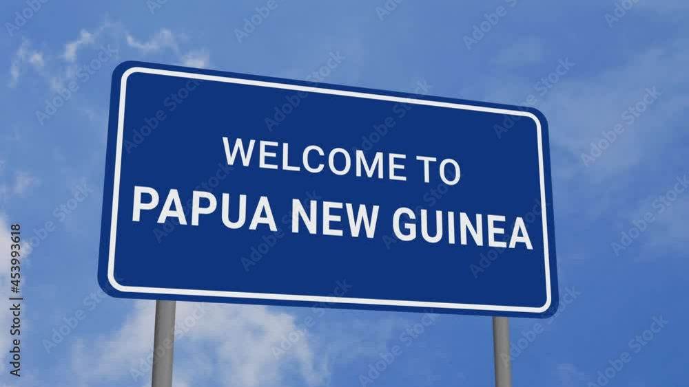Welcome to Papua New Guinea Road Sign on Clear Blue Sky with Rapid Moving Clouds Welcome to Papua New Guinea Road Sign on Clear Blue Sky with Rapid Moving Clouds