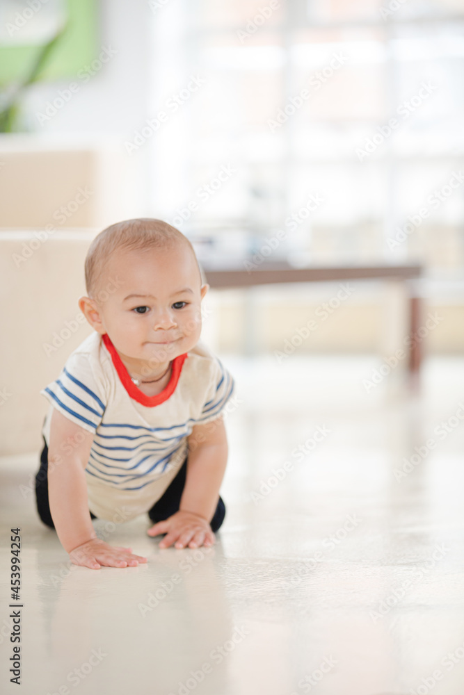 Baby boy crawling on living room floor Baby boy crawling on living room floor