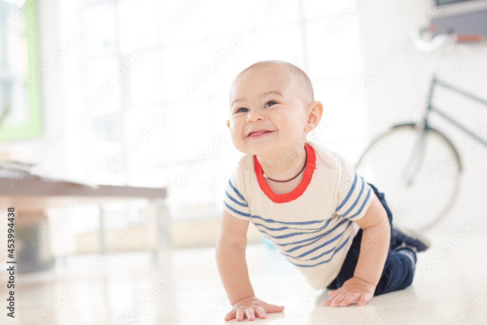 Baby boy crawling on living room floor Baby boy crawling on living room floor