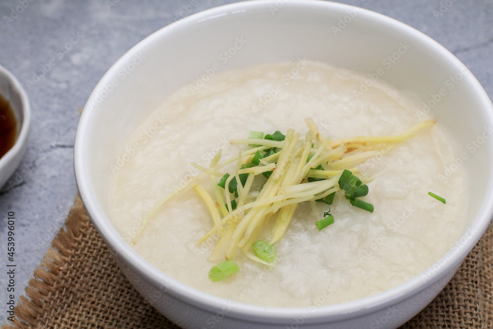 Rice porridge or Congee with fresh ginger and coriander, is a favorite breakfast for south east asian people. Rice porridge or Congee with fresh ginger and coriander, is a favorite breakfast for south east asian people.